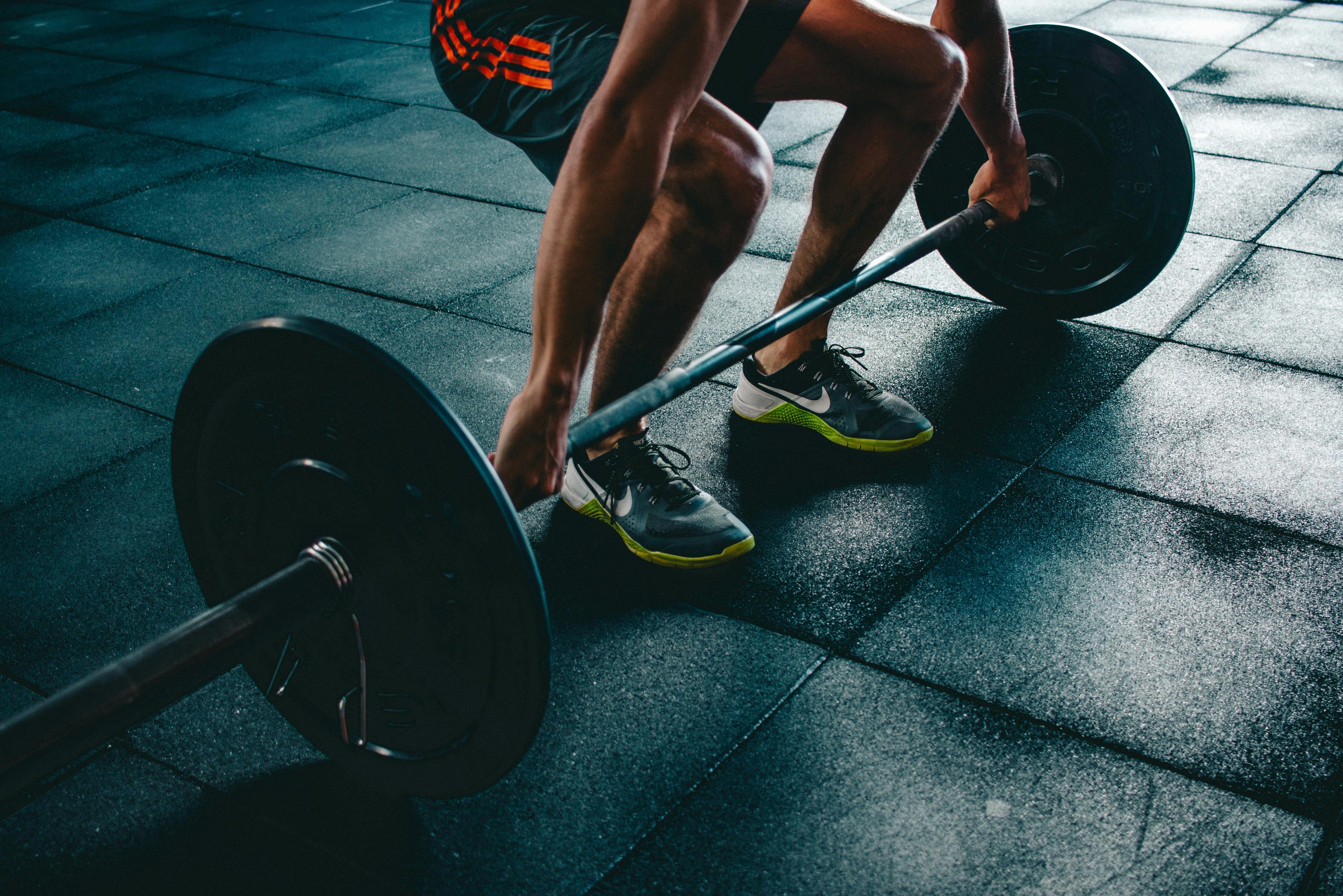 Person doing deadlift exercise in gym
